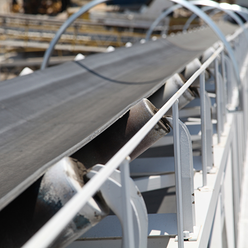 Black conveyor belt on silver rollers