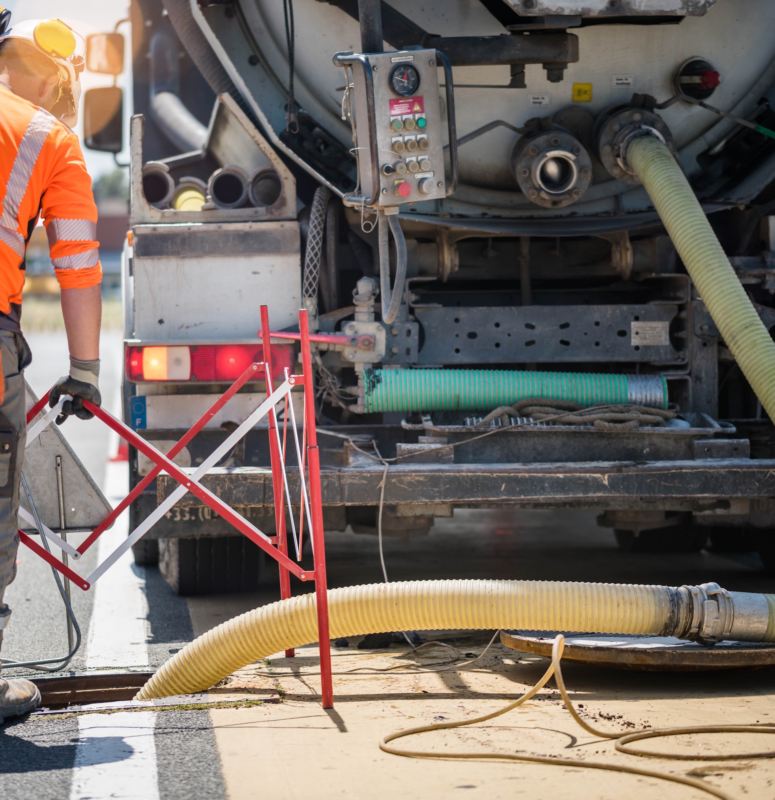 Industrial hose being used on a public street.